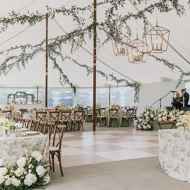 This wedding dance floor has been covered in a pastel beige and white checkerboard pattern, matching the rest of the bride's colors.