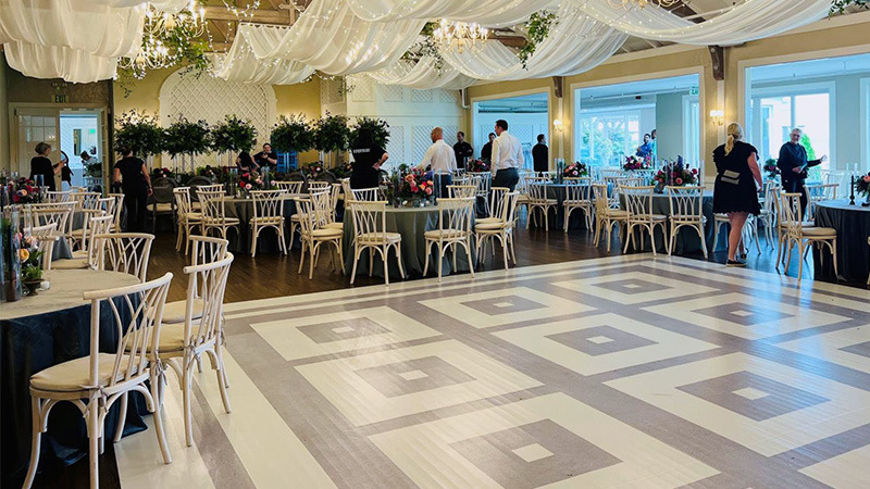 An intricate white marble and grey marble checkerboard pattern has been printed on a vinyl dance floor wrap for this fancy wedding.