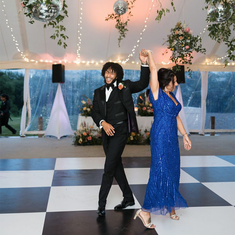 The dance floor at this wedding has been covered with a very large black and white checkerboard pattern. Larger tiles provide a less "busy" look than smaller tiles.