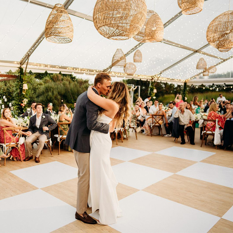 All of the colors and patterns at this outdoor wedding were inspired by nature, so the dance floor wrap was printed with a checkerboard pattern of alternating white and wood grain tiles.