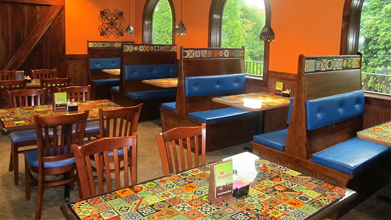 Bright and bold colors are standard décor in most fast casual Mexican restaurants. Artifacturing, specialists in design and manufacturing, used printed surface coverings to cover all of the tables in the restaurant with designs of colorful Mexican tiles.