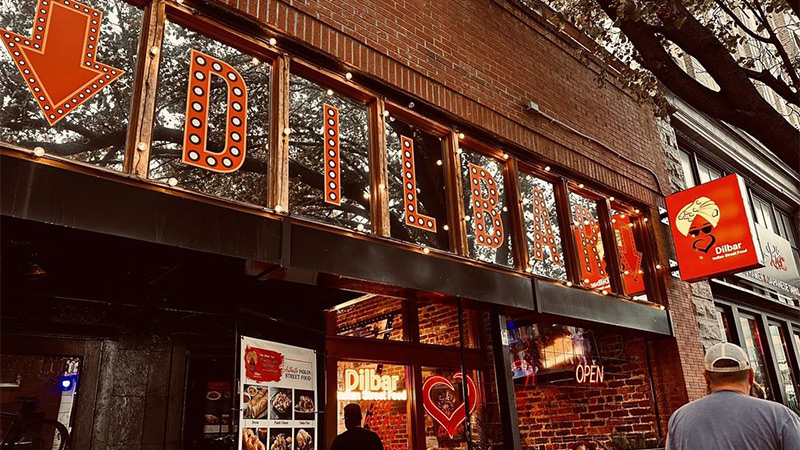Dilbar, an Indian restaurant in NC uses complementary external & internal graphics and wallpaper murals to create their funky vibe and draw in street traffic. Custom, contour-cut letter decals spell out the name of the restaurant using their unique font.