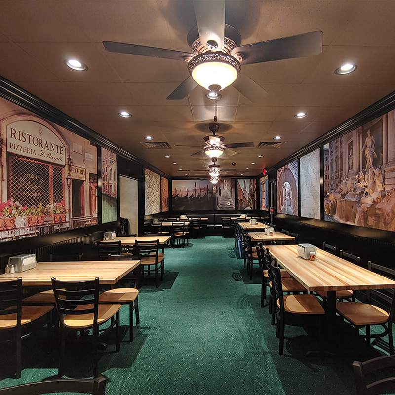 The main dining room at Monical's Pizza in Bradley, IL is decorated with a series of medium-sized wallpaper murals featuring scenes and vistas from all over Italy. When you're here, there's no doubt you're eating authentic Italian cuisine.