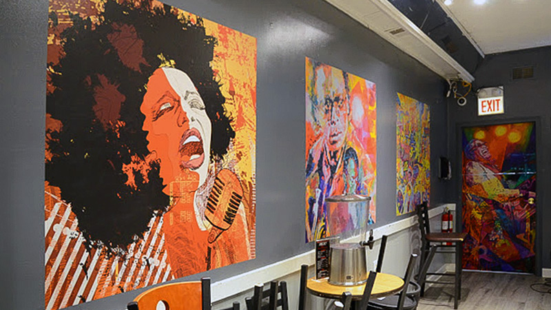 A series of smaller wallpaper murals featuring jazz legends Miles Davis and Billie Holiday decorate Red Pepper's Lounge in Chicago. The bar and restaurant hosts live music nightly.