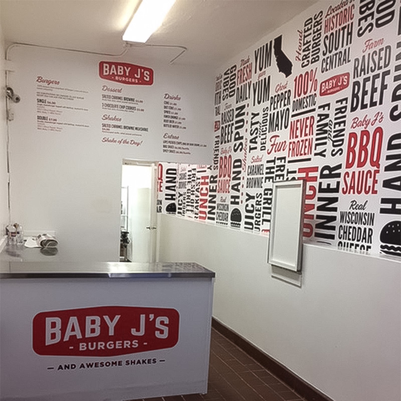 Baby J's Burgers in Los Angeles is a quick serve restaurant that makes sure you don't forget their name. This photo shows the full sized, word cloud wallpaper mural we created for them that includes terms such as “farm raised beef” and “BBQ Sauce.”
