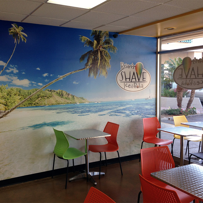 This Boba Shave Ice café got a tropical makeover when they installed a wallpaper mural of wind blown palm trees on a Caribbean island in their dining room. The mural is visible from the giant windows fronting the restaurant and brings in foot traffic.
