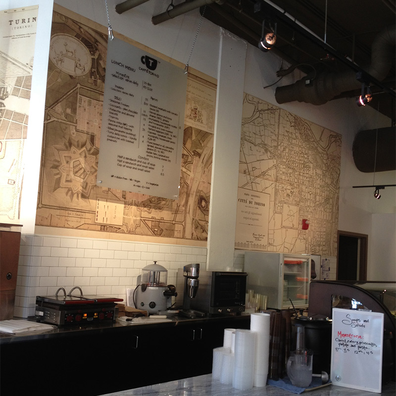 Seattle coffee shop Caffe Torino features vintage maps of Torino, Italy, giving the restaurant a timeless look that ties into a history of tasty food, cappuccinos, espressos and strong coffee beverages.