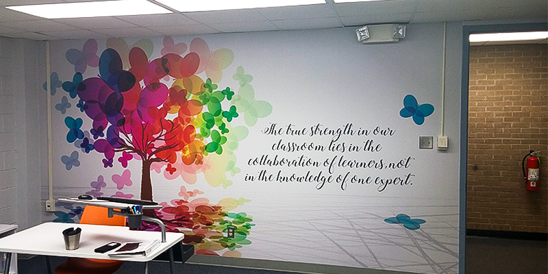 A large, die cut wall decal in the shape of the state of North Carolina features the Eagle Pride mascot and motto of Harnett Primary School. Contour cut stickers like this can really spruce up a cinder block wall.