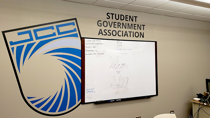 Not all contour cut wall decals feature a school mascot. This large wall sticker, at a community college, adorns the wall of the student government association. Wall decals are the perfect way to identify an otherwise nondescript office space.