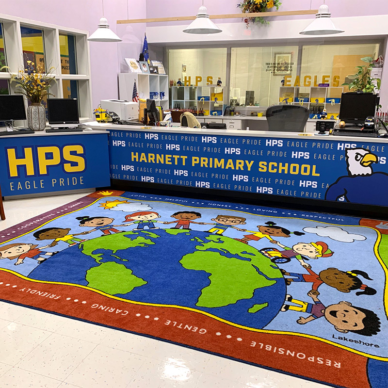 The reception desk in the school admin office at Harnett Primary School leaves no doubt that the entire school is full of “Eagle Pride,” one of the schools mottos. The wallpaper wrap features a step and repeat pattern as well as the school’s Eagle mascot.