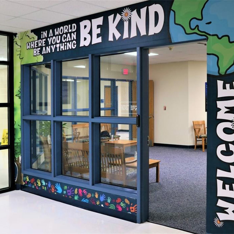 This door surround wallpaper mural reminds students to be kind while welcoming them into the school’s offices. Motivational and inspirational messaging in schools can be carried out very well with murals and graphics like these.