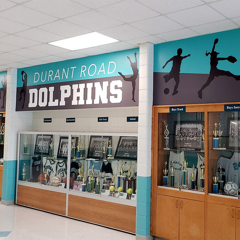 Wall murals and wall graphics like these enhance the appeal of the trophy case at Durant Road Middle School in Raleigh, NC.