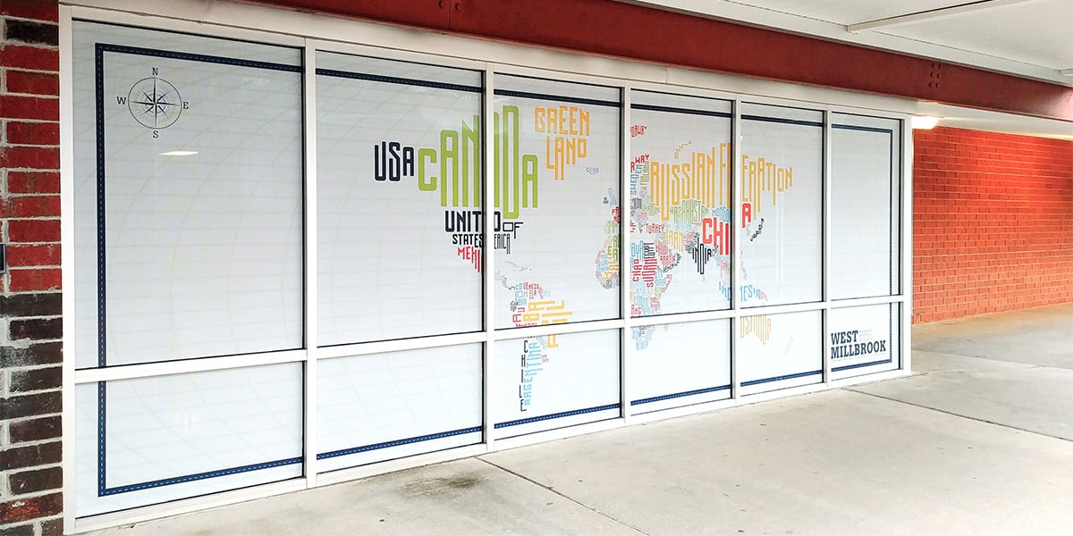 At West Millbrook Magnet Middle School, the entrance is adorned with a giant world map populated by word art depicting the names of each country. The installation was done on large paned windows using perforated window film providing privacy.
