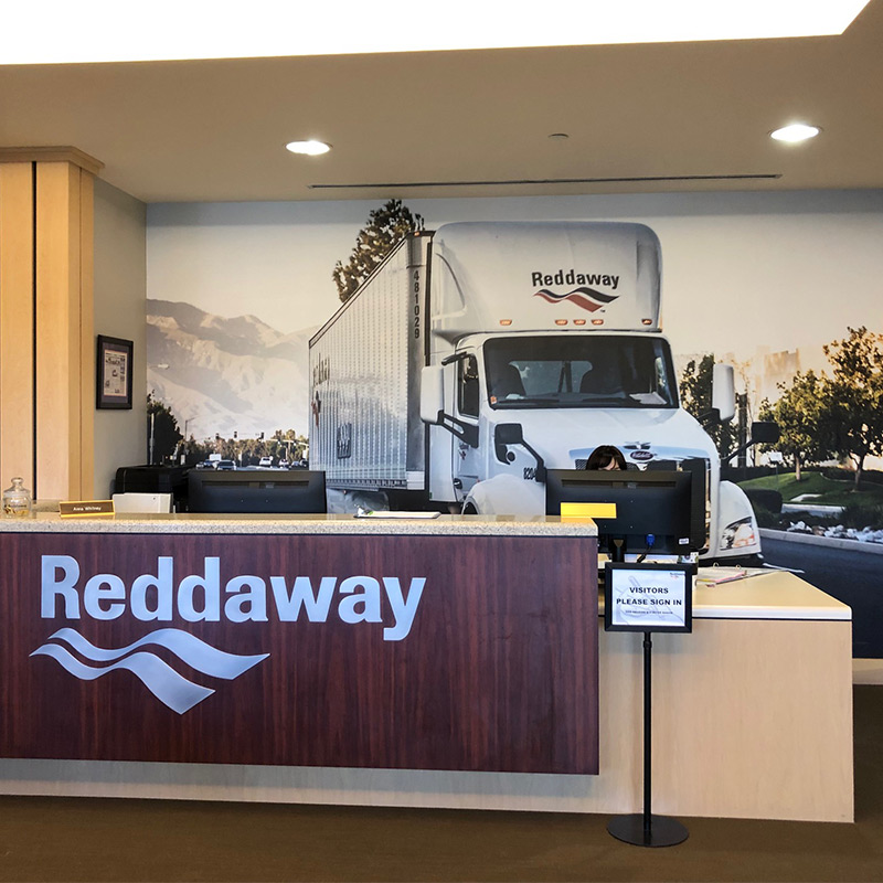 A large custom mural of a delivery truck in the reception area of a trucking company.