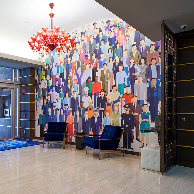 People of all types and professions are represented in a wallpaper mural in a corporate lobby.