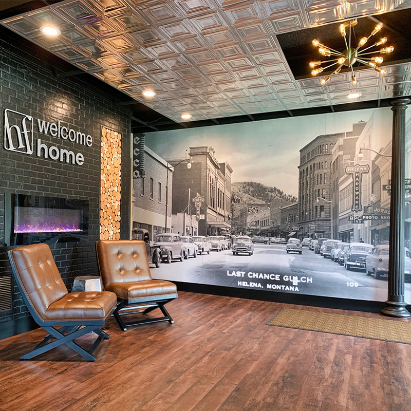 A printed wall mural featuring an historic vintage photo of a corporate headquarters hometown main street.