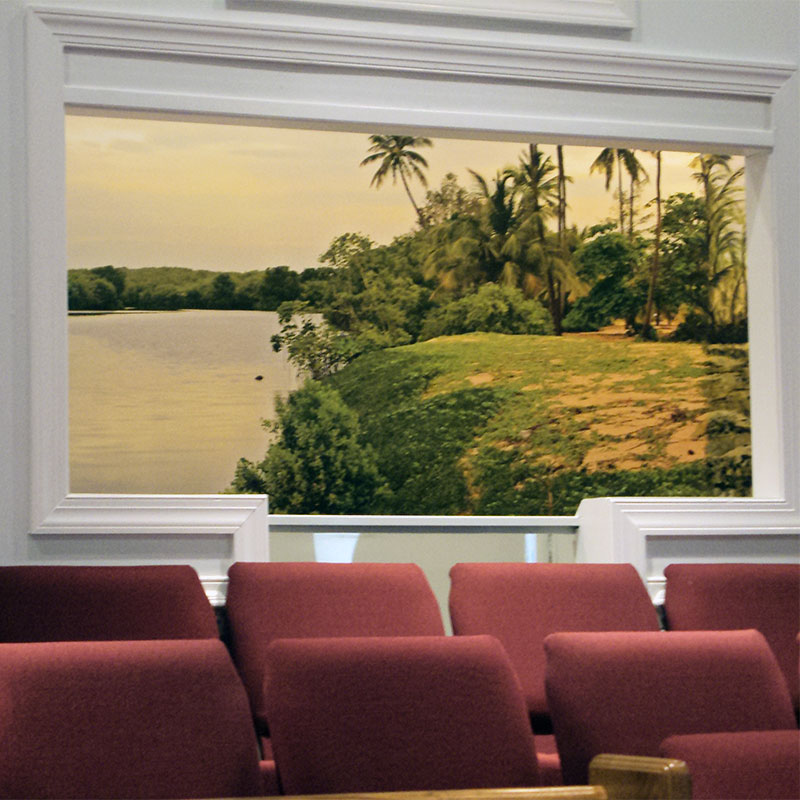 A modern Baptist church's baptistry in decorated with a wallpaper wall mural featuring the River Jordan, the scene of Jesus' baptism by John The Baptist.
