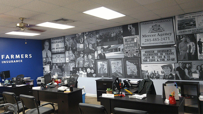 An insurance office decorated with a wallpaper mural featuring a collage of photos from the company's history.