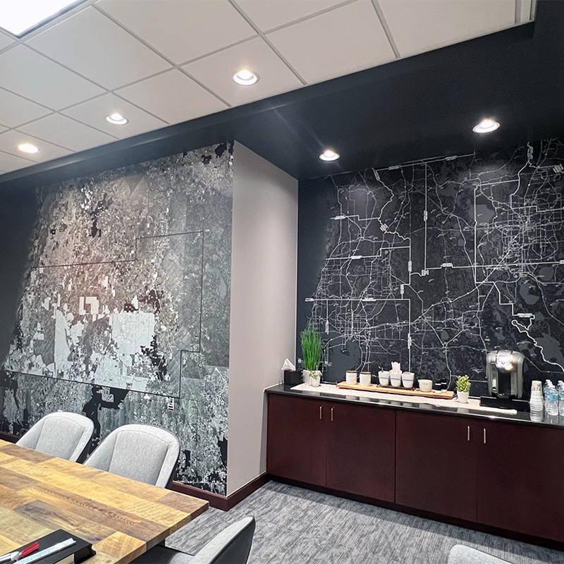 Artistic maps have been used to create custom wall murals for this upscale conference and meeting room at the company offices.