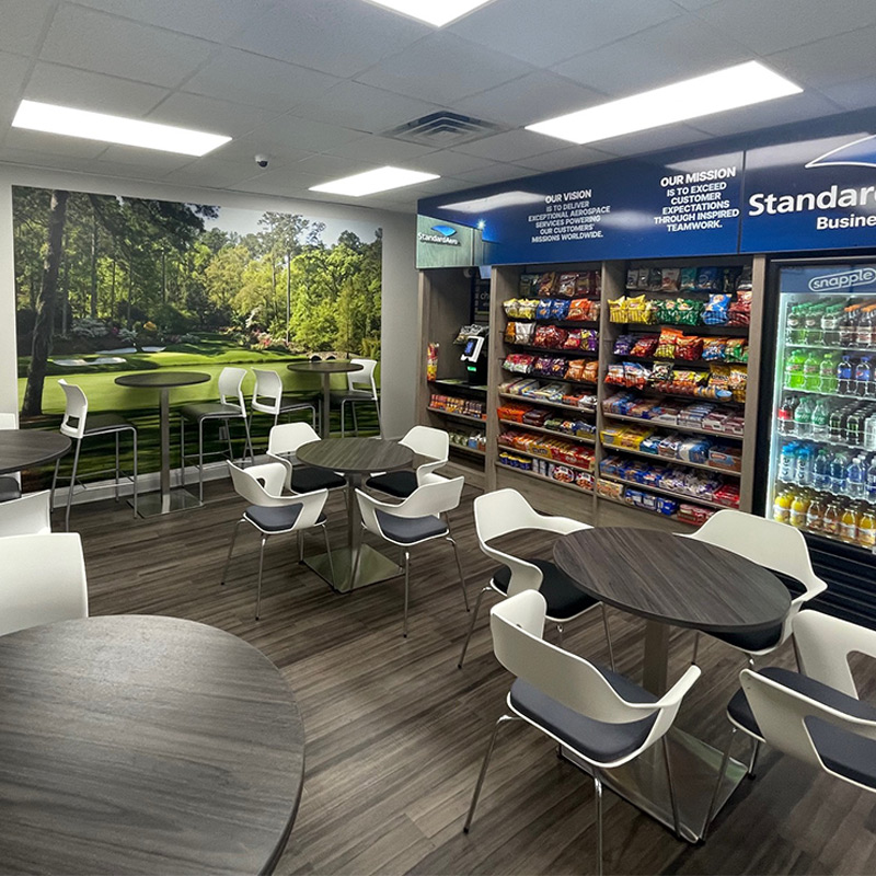 A golf course mural featuring the well known Master's hole at Augusta National graces this company lunchroom.
