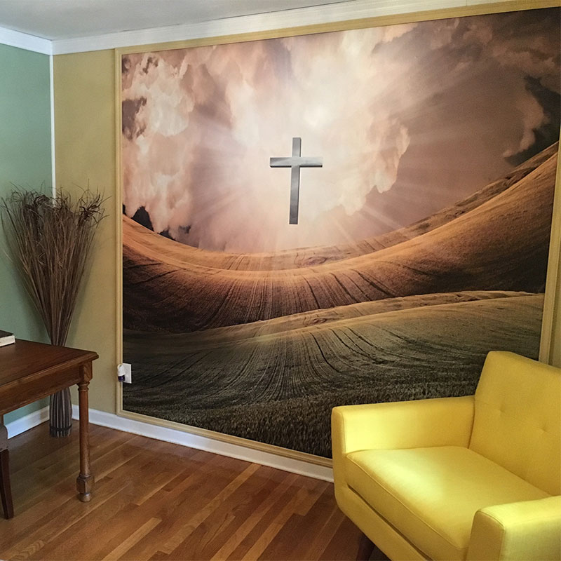 One of our most popular Christian-themed wall murals is "Light of the Cross." Here it is used to provide a spiritually motivating vibe in a ministry office of a church.
