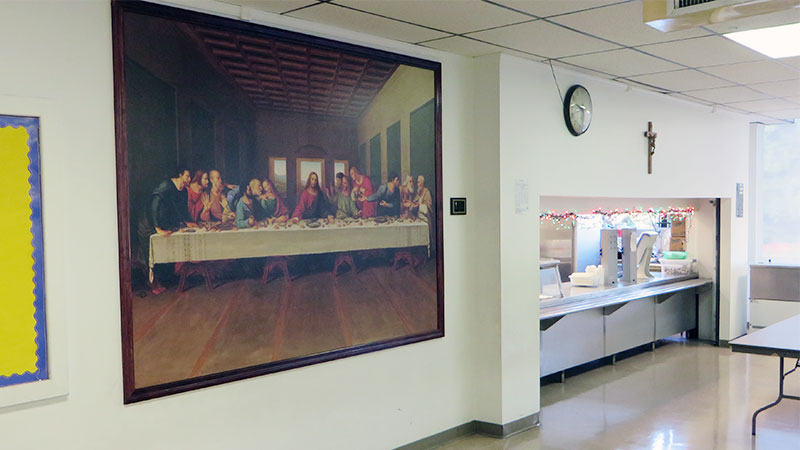 A wall mural depicting Leonardo Da Vinci's "The Last Supper" has been framed for a nicely finished look. It hangs just outside the dining hall at this church reception area.