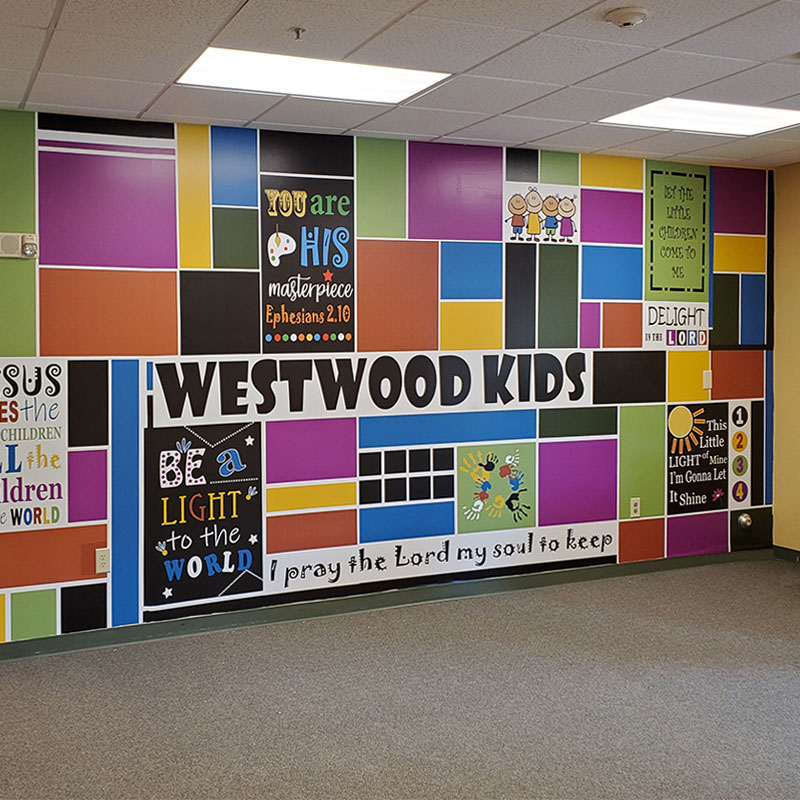 Bright colors, an abstract design and kid-friendly Bible verses feature in this wall mural wallpaper outside the youth ministry at Westwood church.