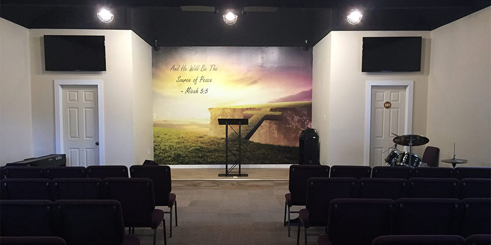 A small modern church with a custom mural featuring a favorite psalm.