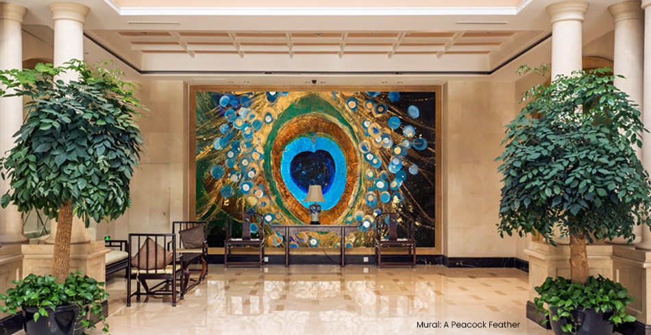 hotel lobby featuring large-scale peacock feather painted artwork mural with greens and blue and teals and golden hues